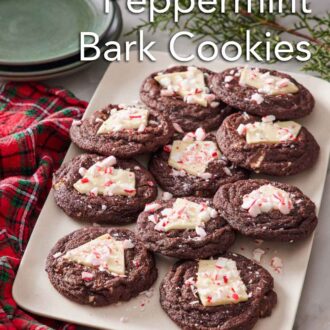 Pinterest graphic of a platter of chocolate peppermint bark cookies. Decorative pines, plates, and a linen napkin surrounding the platter.