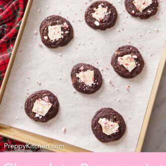 Pinterest graphic of eight chocolate peppermint bark cookies on a parchment-lined sheet pan.