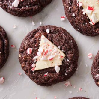 Overhead view of chocolate peppermint bark cookies topped with crushed candy canes.