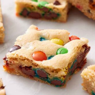 M&M cookie bars on a marble surface.