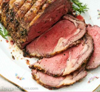 Pinterest graphic of prime rib on a serving platter with four slices cut in front.