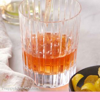 Pinterest graphic of Sazerac poured into a glass.