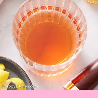 Pinterest graphic of an overhead view of a glass of Sazerac.