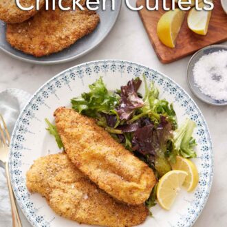 Pinterest graphic of a plate with crispy air fryer chicken cutlets along with a side of mixed greens and lemon wedges.