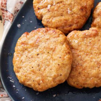 A close up view of air fryer chicken patties on a platter with a fork on the side.
