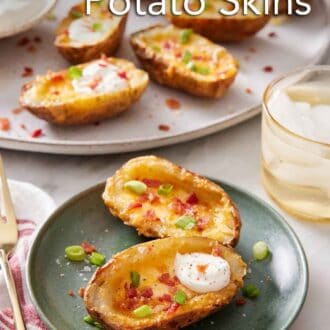 Pinterest graphic of a plate with two air fryer potato skins with a platter in the background with more air fryer potato skins.