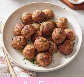 Pinterest graphic of a bowl of air fryer turkey meatballs garnished with chopped parsley.