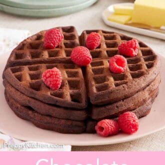 Pinterest graphic of a stack of three chocolate waffles topped with fresh raspberries.