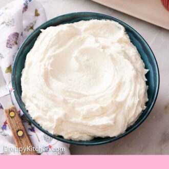 Pinterest graphic of a bowl of ermine frosting with frosted cupcakes on the side.