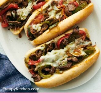 Pinterest graphic of an overhead view of three Philly cheesesteak sandwiches on a platter.