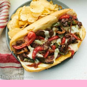 Pinterest graphic of a plate of Philly cheesesteak with chips.