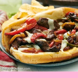 Pinterest graphic of a close up view of a plate of Philly cheesesteak with chips.