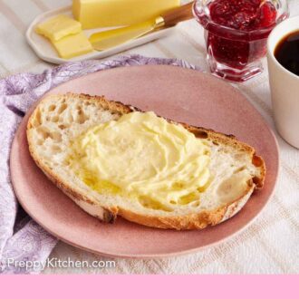 Pinterest graphic of a plate with a slice of sourdough bread with butter spread on top.