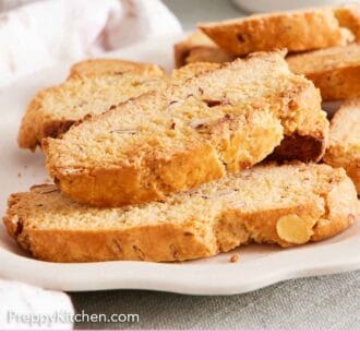 Pinterest graphic of a side view of a white platter of biscotti.