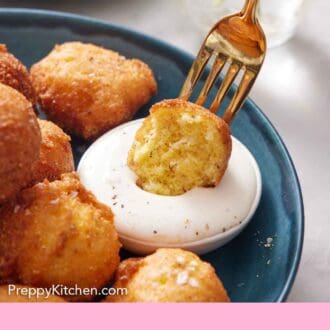 Pinterest graphic of a fork dipping half of a hush puppy into a small bowl of dipping sauce.