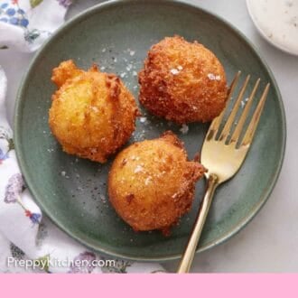 Pinterest graphic of a plate with three hush puppies with a fork.