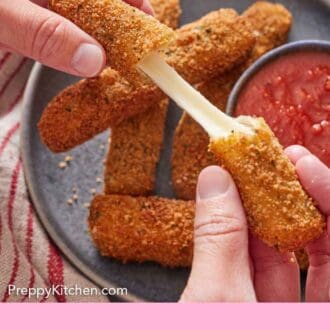 Pinterest graphic of a hand pulling a mozzarella stick in half.