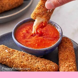 Pinterest graphic of half of a mozzarella stick dipped into a small bowl of marinara sauce.