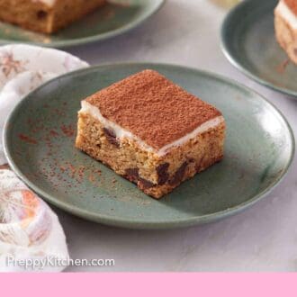 Pinterest graphic of plated serving of pieces of tiramisu blondies with one plate in front.