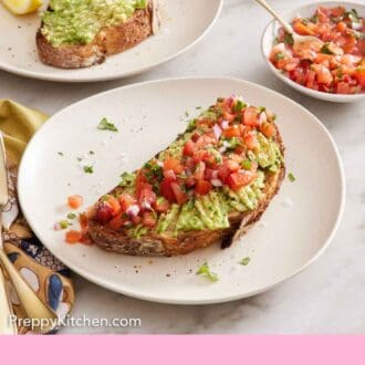Pinterest graphic of two plates of avocado toast, one topped with pico de gallo.