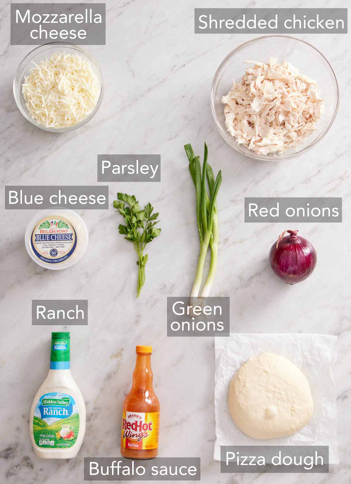 Ingredients needed to make buffalo chicken pizza.