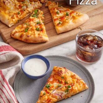 Pinterest graphic of a plate with a slice of buffalo chicken pizza with a bowl of dip. The rest of the pizza in the back with more buffalo sauce on the side and a glass of soda.