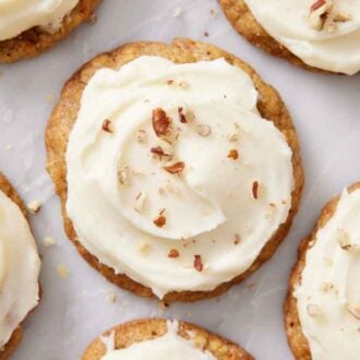 Overhead view of carrot cake cookies topped with chopped pecans.