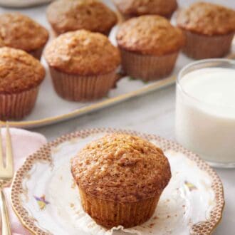 Pinterest graphic of a carrot muffin with the liner pulled down on a plate. A glass of milk in the background with a platter of more muffins.