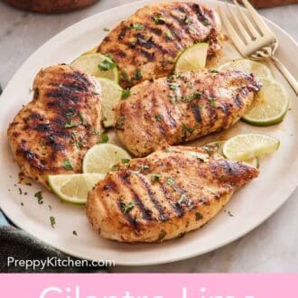 Pinterest graphic of a platter with four cilantro lime chicken along with cut limes and a fork.