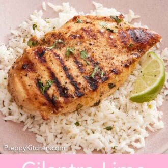 Pinterest graphic of a plate with a cilantro lime chicken on top of a bed of rice.