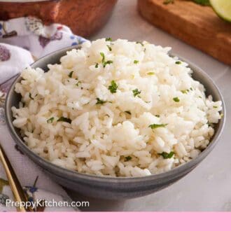 Pinterest graphic of a bowl of cilantro lime rice with chopped cilantro on top.