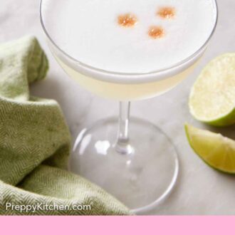 Pinterest graphic of a glass of pisco sour with a lime garnish.