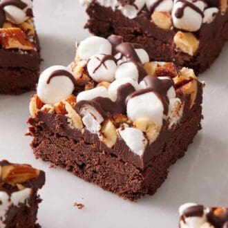 Cut rocky road bars on a marble surface.