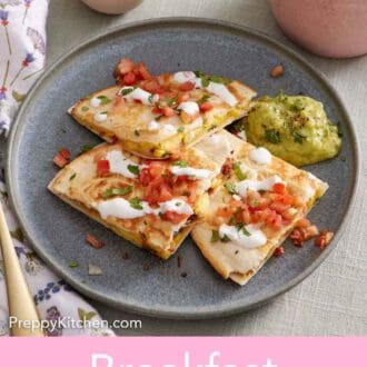 Pinterest graphic of a plate with three pieces of breakfast quesadillas topped with pico de gallo, sour cream, and guacamole.