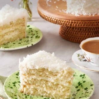 Pinterest graphic of a slice of coconut cake on a plate. In the background is another plated slice and the rest of the cake on a cake stand.