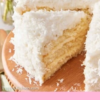 Pinterest graphic of a slice of coconut cake cut from the cake on a cake stand.