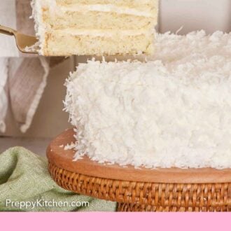 Pinterest graphic of a slice of coconut cake lifted from a cake on a cake stand.
