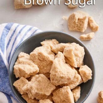 Pinterest graphic of an overhead view of brown sugar in chunks in a bowl. More hardened brown sugar scattered around.