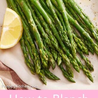 Pinterest graphic of a platter of blanched asparagus with a lemon wedge topped with pepper.