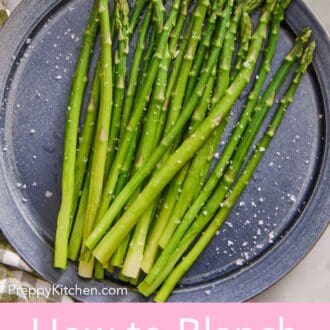 Pinterest graphic of an overhead view of a large plate of blanched asparagus topped with flaky salt.