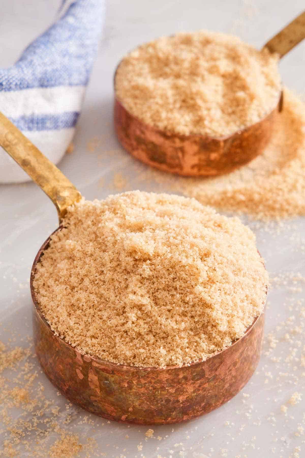 Two scoops of softened brown sugar. More brown sugar scattered around.