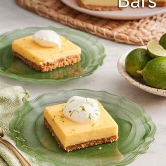 Pinterest graphic of two plates with key lime pie bars topped with whipped cream and lime zest.