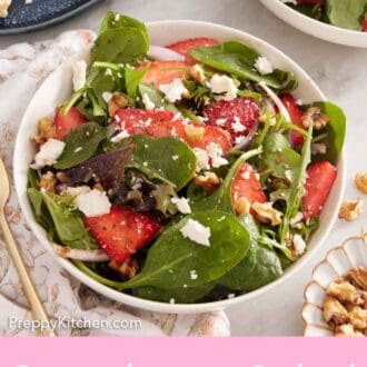 Pinterest graphic of a bowl of strawberry salad with another bowl of salad and chicken off to the side.