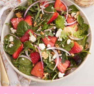 Pinterest graphic of a plate of strawberry salad with a fork on the side along with a drink and bowl of chopped nuts.
