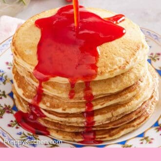 Pinterest graphic of strawberry syrup poured over a stack of pancakes on a plate.