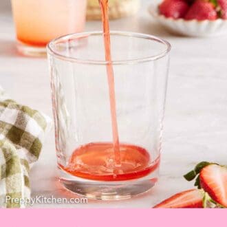 Pinterest graphic of strawberry syrup added to a glass cup.