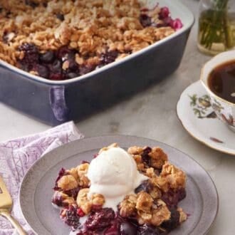 Pinterest graphic showing fruit crisp on a small plate with ice cream. A cup of coffee and a baking dish with more crisp is in the background.
