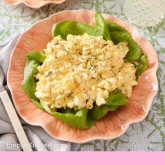 Pinterest graphic showing salad made of eggs, herbs, mayonnaise, and mustard served over lettuce leaves.