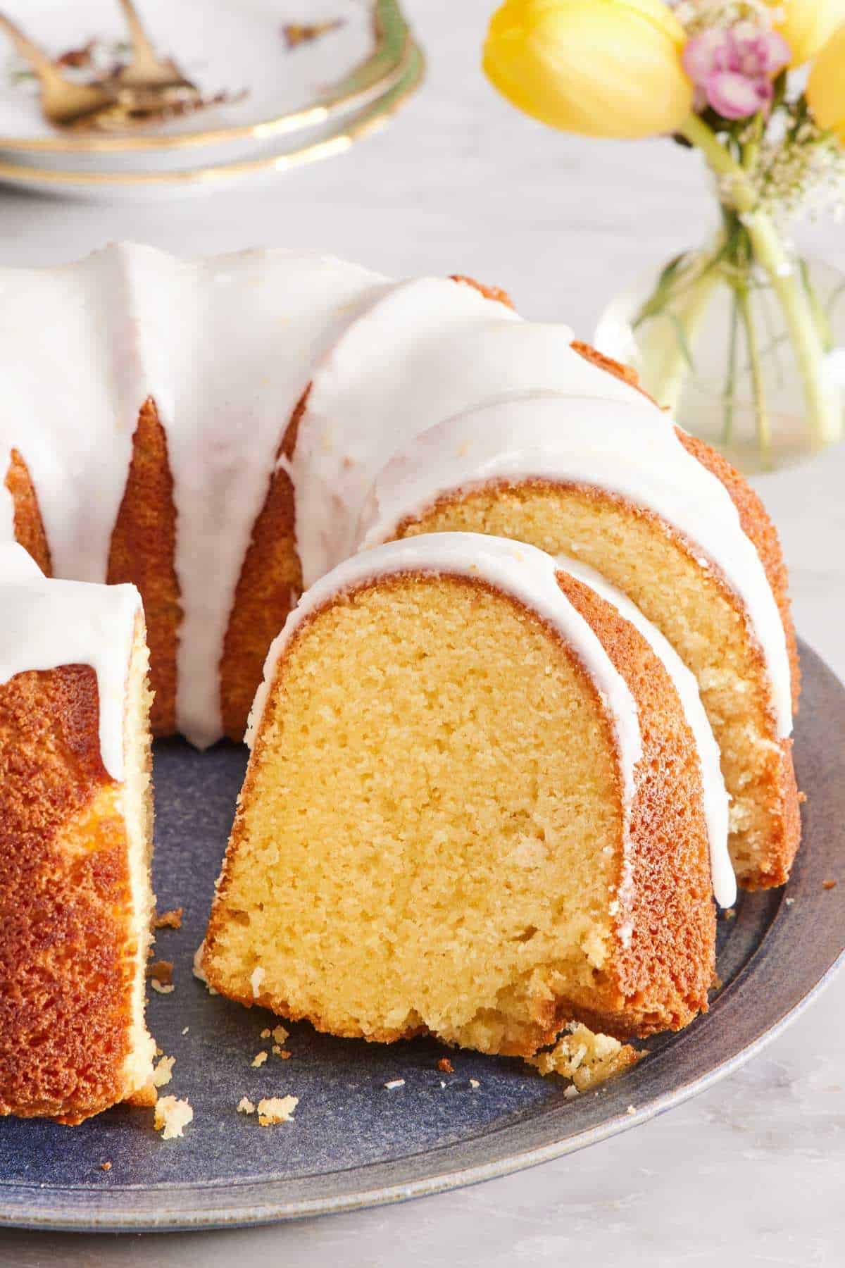 Close-up of a bundt cake with powdered sugar and lemon glaze.