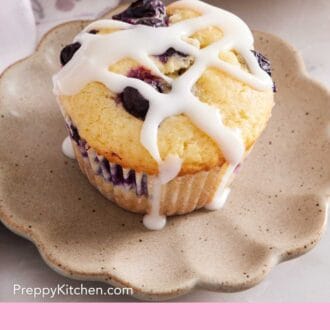 Pinterest graphic of a blueberry muffin on a plate with glaze drizzled on top.